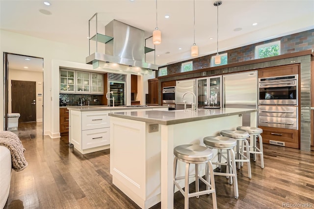 235 Eudora St, Denver, CO 80220 - kitchen featuring ventilation hood, a spacious island, dark wood finished floors, and recessed lighting