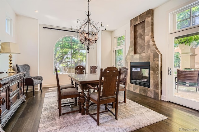 235 Eudora St, Denver, CO 80220 - dining area featuring a chandelier, wood finished floors, a fireplace, and recessed lighting