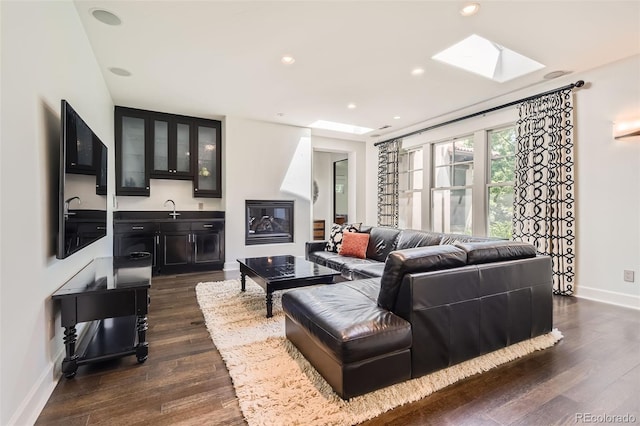 235 Eudora St, Denver, CO 80220 - living area featuring a skylight, dark wood-style flooring, and recessed lighting