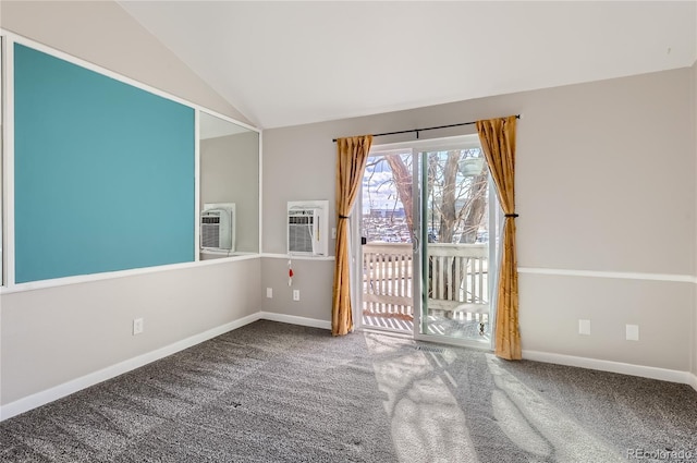 carpeted empty room featuring vaulted ceiling