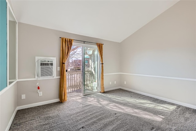 carpeted empty room with lofted ceiling and an AC wall unit