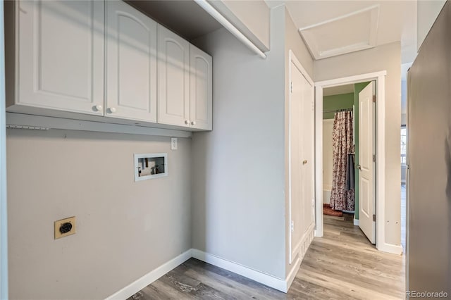 laundry room featuring cabinets, hookup for a washing machine, light hardwood / wood-style flooring, and electric dryer hookup