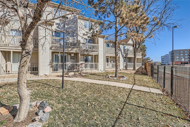 rear view of property with a lawn