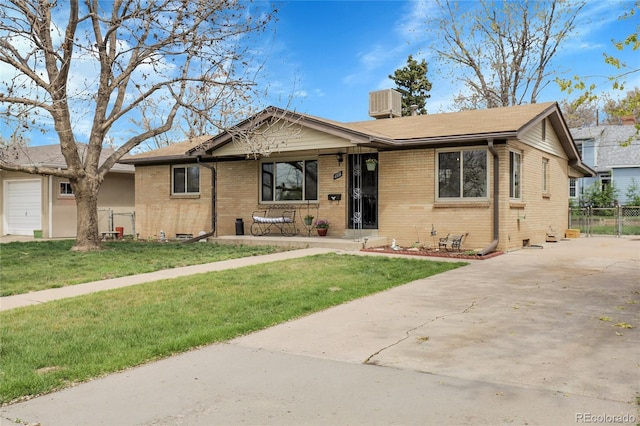 view of front of property featuring brick siding, a front lawn, and concrete driveway