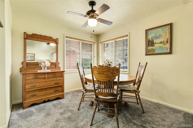 dining room with baseboards, carpet flooring, a textured ceiling, and ceiling fan