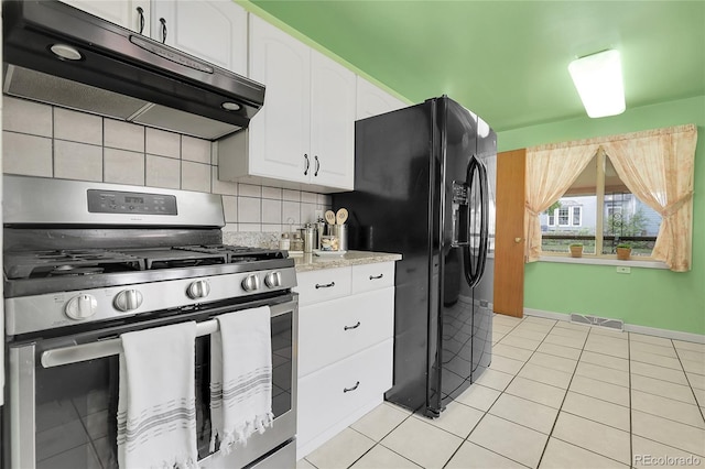 kitchen with white cabinets, stainless steel range with gas cooktop, black refrigerator with ice dispenser, under cabinet range hood, and light tile patterned flooring
