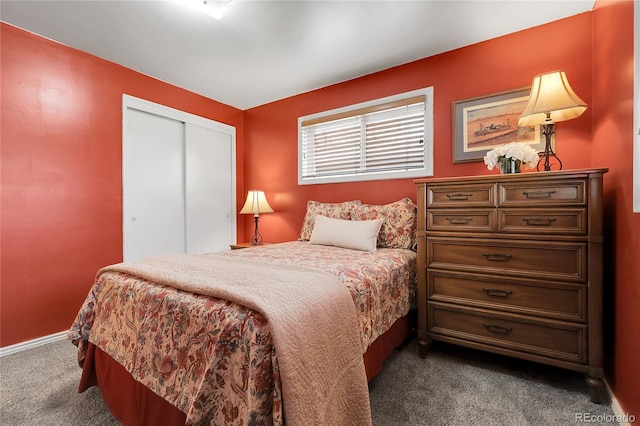 bedroom featuring baseboards, a closet, and dark carpet