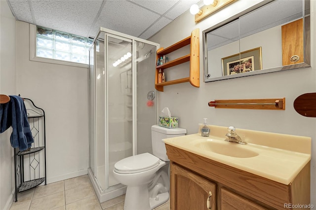 bathroom with vanity, tile patterned flooring, a stall shower, and toilet