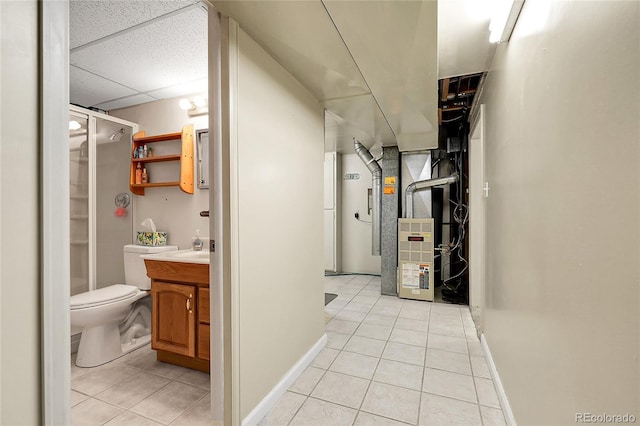interior space featuring baseboards, heating unit, and light tile patterned flooring