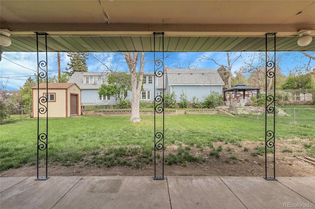 exterior space featuring fence, an outdoor structure, a gazebo, and a shed