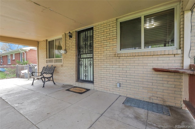 view of patio featuring fence and covered porch