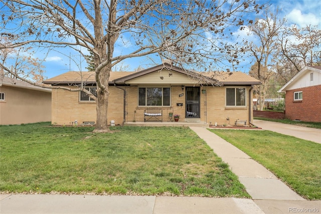 view of front of property with brick siding and a front yard