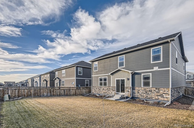 rear view of property featuring a yard