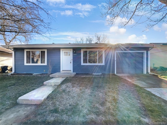 ranch-style home with a garage and a front lawn