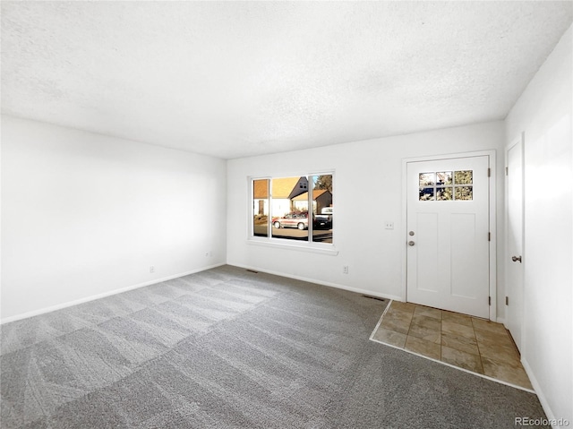 entrance foyer with carpet and a textured ceiling