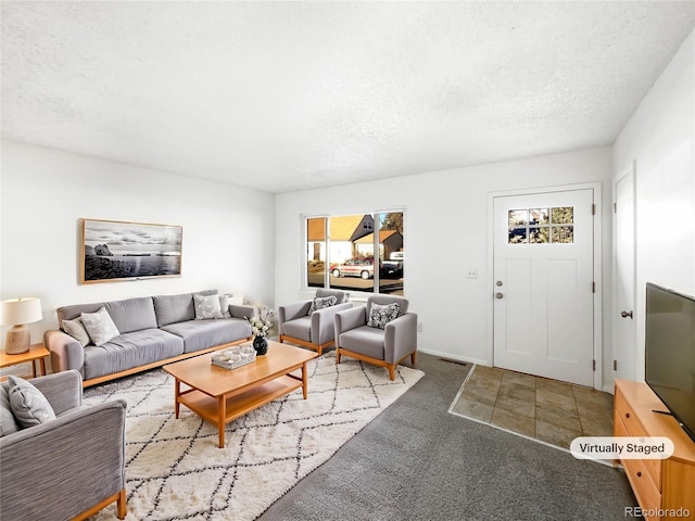 carpeted living room featuring a textured ceiling