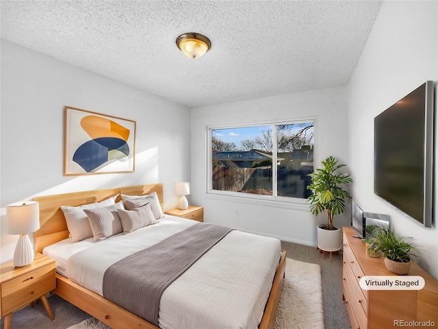 bedroom with carpet and a textured ceiling