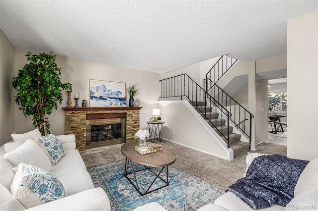 living room featuring light colored carpet, a textured ceiling, and a fireplace