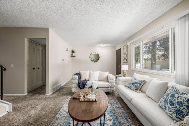 carpeted living room with a textured ceiling