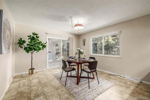 dining area with a textured ceiling