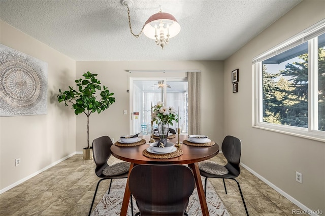 dining room with a chandelier and a textured ceiling