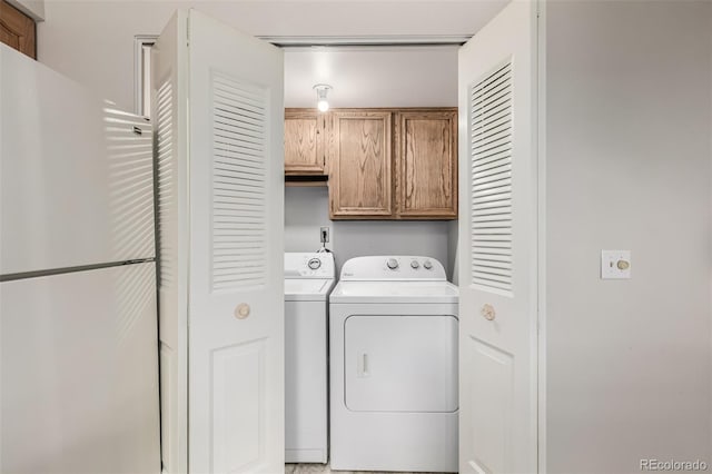 laundry area featuring cabinets and washer and clothes dryer