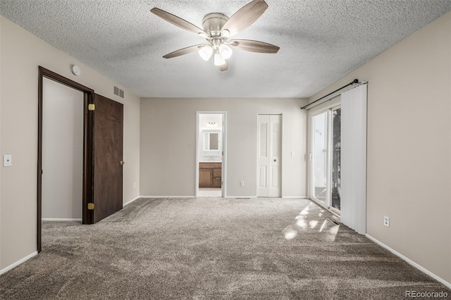 unfurnished bedroom featuring ceiling fan, access to exterior, connected bathroom, carpet floors, and a textured ceiling