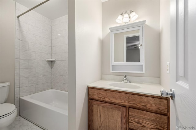 full bathroom with vanity, toilet, and tiled shower / bath combo