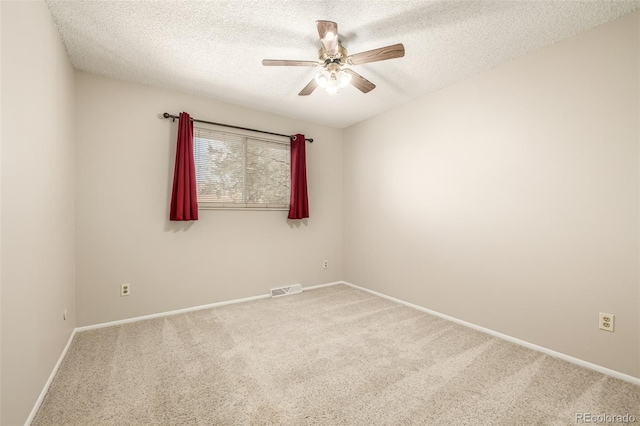 unfurnished room with ceiling fan, carpet flooring, and a textured ceiling