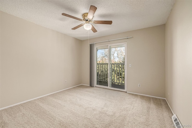 carpeted spare room with ceiling fan and a textured ceiling