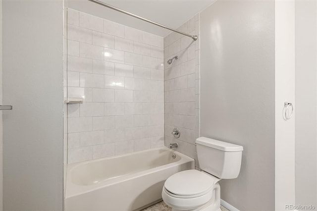 bathroom with toilet and tiled shower / bath combo