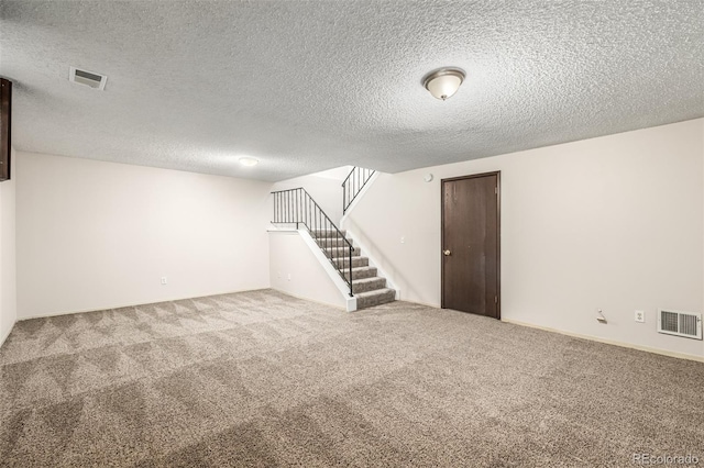 basement featuring carpet floors and a textured ceiling