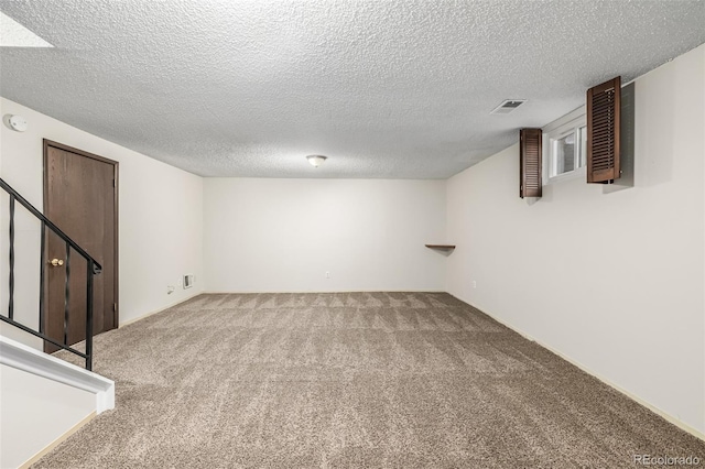 basement with a textured ceiling and carpet