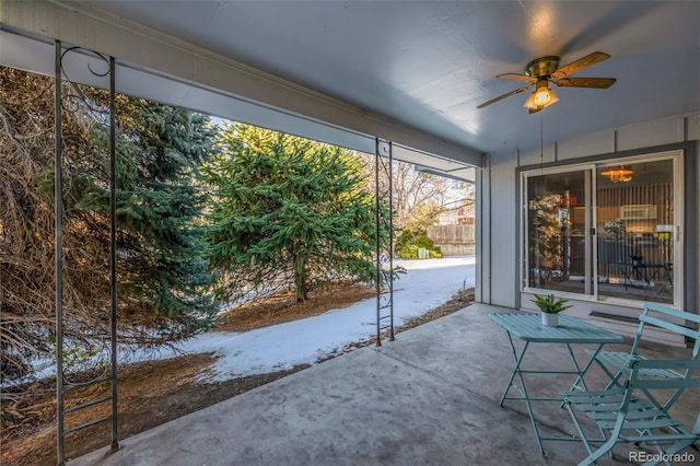 unfurnished sunroom featuring ceiling fan