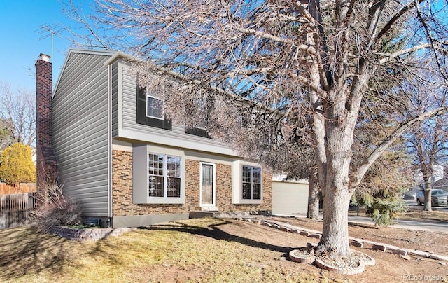 view of front of property featuring a garage and a front yard