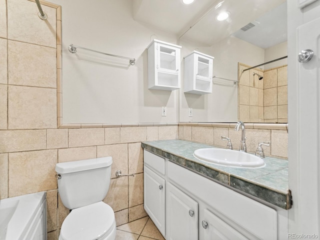 bathroom featuring tile patterned flooring, vanity, tile walls, and toilet