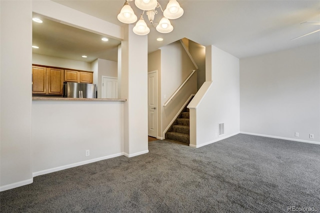 7046 Red Sand Grv, Colorado Springs, CO 80923 - unfurnished living room with a chandelier, carpet floors, baseboards, recessed lighting, and stairway
