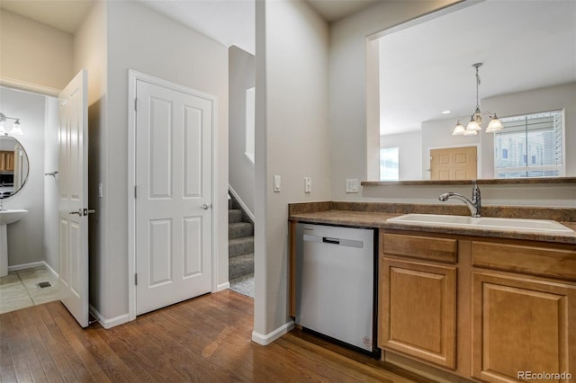 7046 Red Sand Grv, Colorado Springs, CO 80923 - kitchen featuring stainless steel appliances, a sink, a chandelier, dark wood finished floors, and pendant lighting