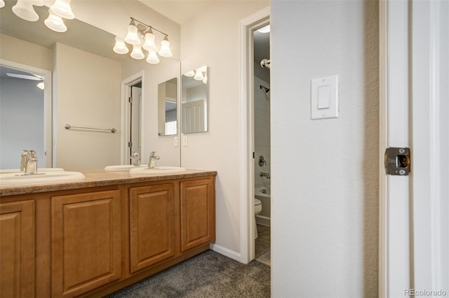 7046 Red Sand Grv, Colorado Springs, CO 80923 - bathroom featuring double vanity and toilet