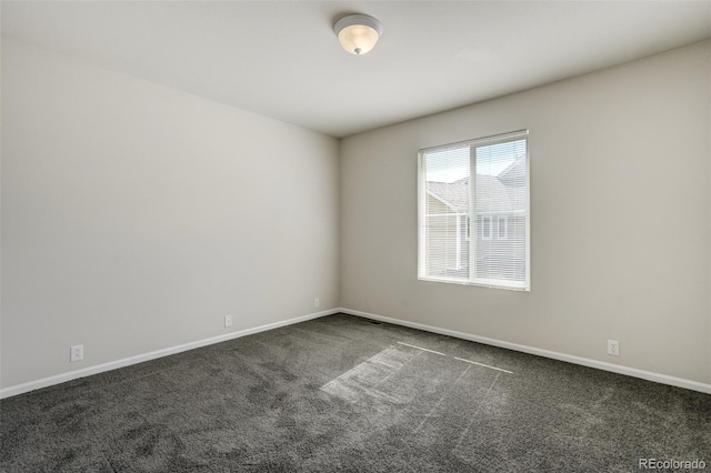 7046 Red Sand Grv, Colorado Springs, CO 80923 - spare room featuring dark carpet and baseboards