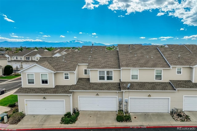 7046 Red Sand Grv, Colorado Springs, CO 80923 - townhome / multi-family property with a mountain view, a residential view, a garage, and a shingled roof