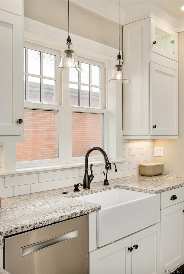 kitchen with a sink, white cabinetry, decorative backsplash, dishwasher, and plenty of natural light