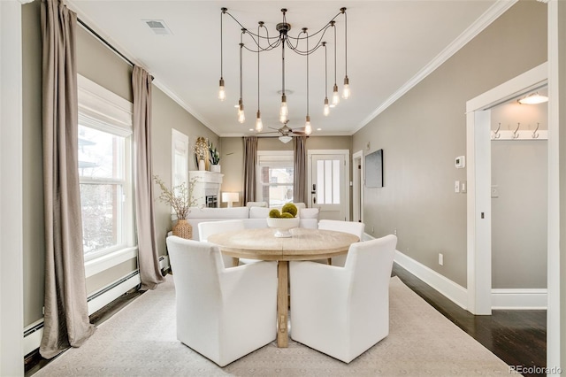 dining space featuring ornamental molding, visible vents, a fireplace, and baseboards