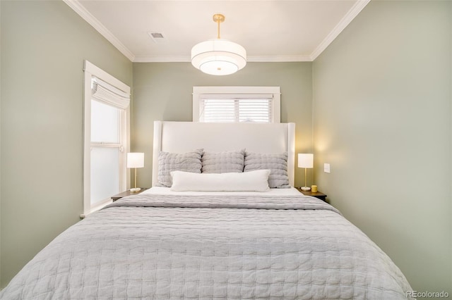 bedroom featuring visible vents and ornamental molding