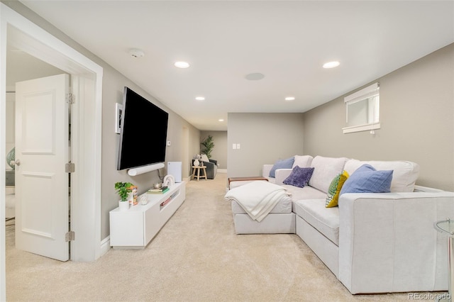 living room featuring light carpet, baseboards, and recessed lighting