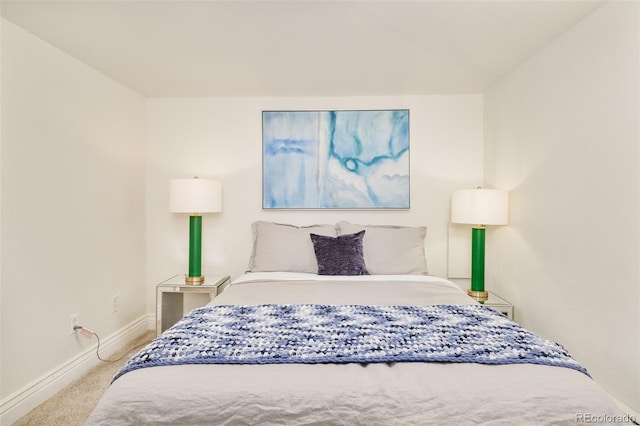 carpeted bedroom featuring baseboards