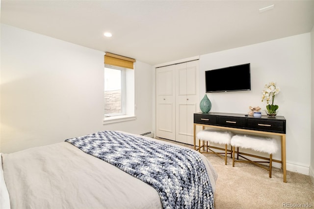 bedroom featuring carpet floors, a baseboard radiator, a closet, and baseboards