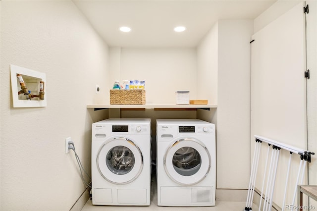 washroom featuring laundry area, recessed lighting, and washing machine and clothes dryer