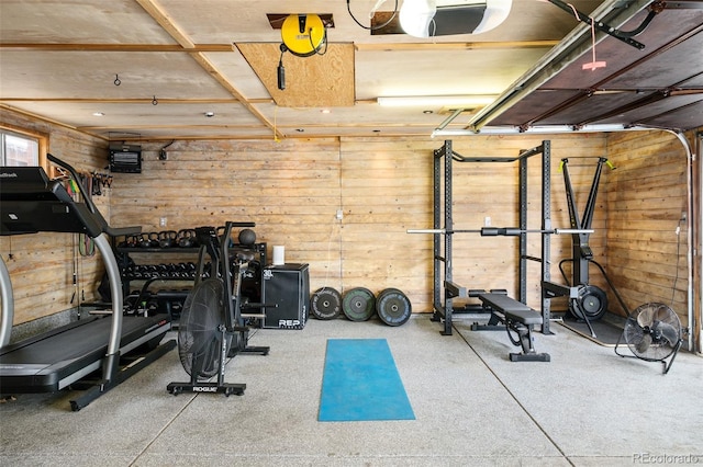 workout area featuring wood walls