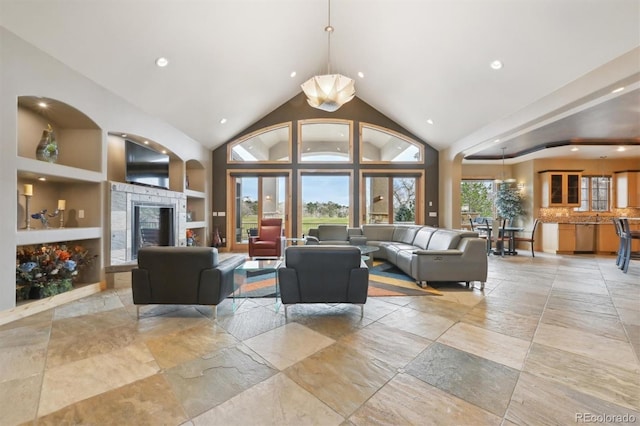 living room with built in features and a towering ceiling